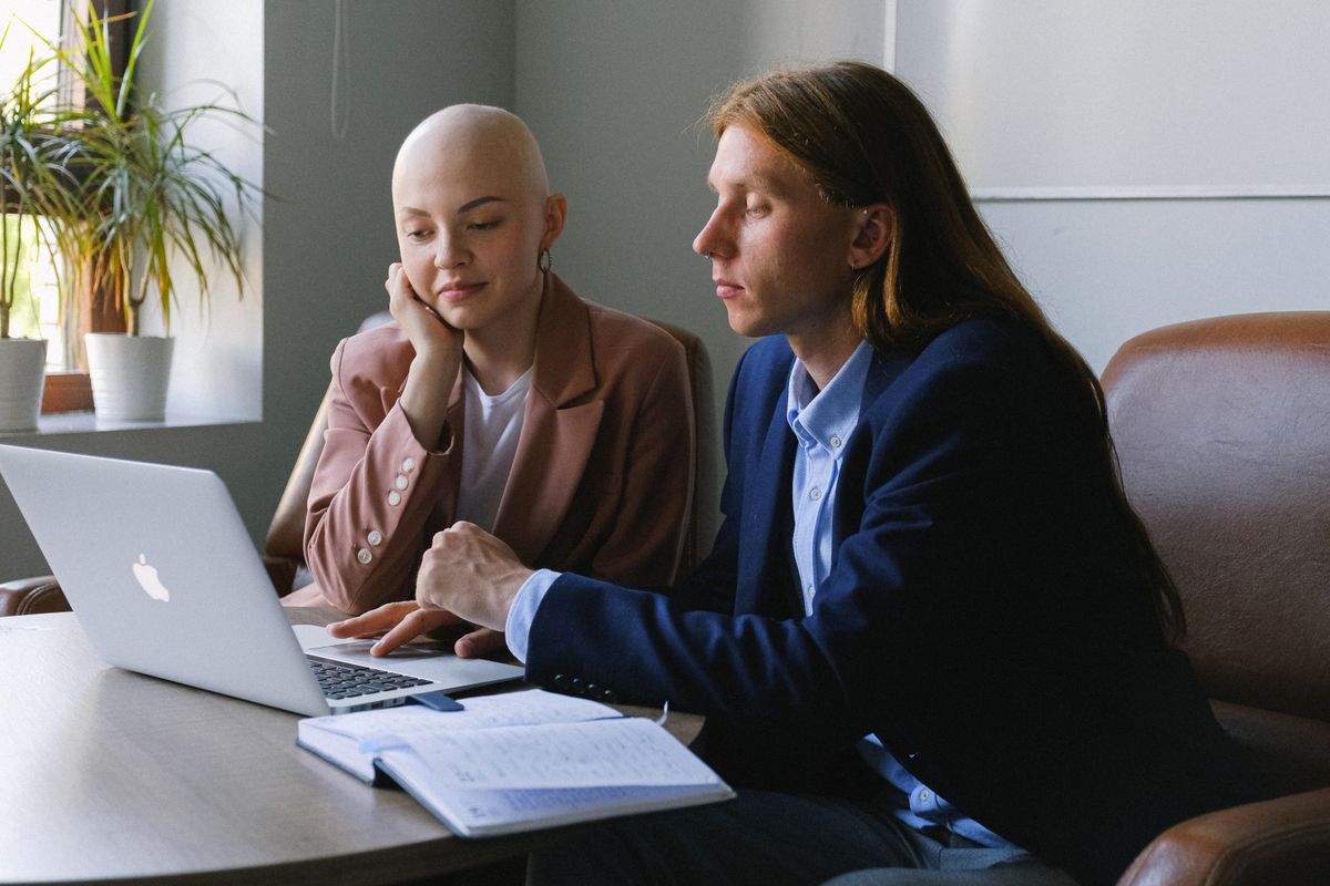 Colleagues reviewing work together at a desk